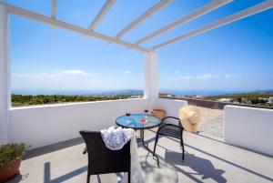 a view from the balcony of a house with a table and chairs at Sun View Villas in Pyrgos