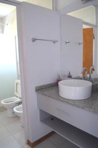a white bathroom with a sink and a toilet at Complejo Costa Ubajay in San José del Rincón