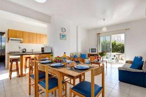 a kitchen and living room with a table and chairs at Philippos Paphos villas - villa 3 in Paphos City