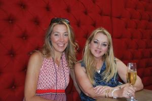 two women sitting next to each other with a glass of wine at Kingna Lodge Montagu in Montagu