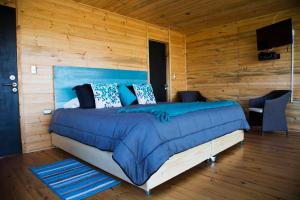Llit o llits en una habitació de Lodge KARKÚ