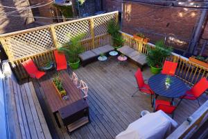 a wooden bench sitting on top of a patio at Wrigley Hostel - Chicago in Chicago