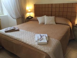 a hotel room with a bed with towels on it at Ad Palatium in Cori
