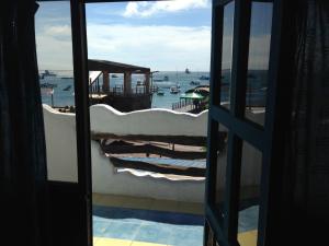 a view of the ocean from a room with a window at Hotel Casa Blanca in Puerto Baquerizo Moreno +16 photos