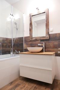 a bathroom with a sink and a mirror at Super-Apartamenty VIP Vintage in Poznań