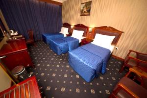 Postel nebo postele na pokoji v ubytování Mount Royal Hotel
