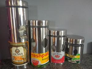 a group of four metal containers sitting on a counter at East Cottage in Boksburg