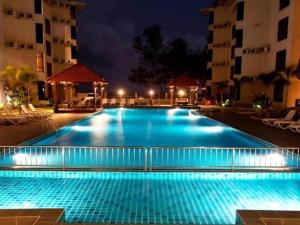 a large swimming pool with blue lights in a hotel at Samsuria Beach Apartment in Kuantan