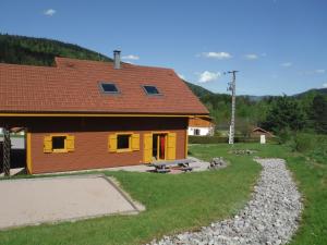 a house with a picnic table in front of it at Les airelles in Gérardmer