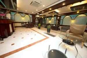 a living room with a couch and a glass table at Mount Royal Hotel in Dubai