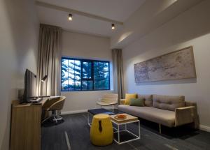 a living room with a couch and a desk at Quest Fremantle in Fremantle