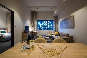 a room with a dining table and a living room at Quest Fremantle in Fremantle