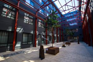 a large building with a tree in the middle of it at Quest Fremantle in Fremantle