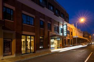 a city street at night with buildings and street lights at Quest Fremantle in Fremantle