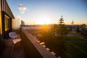 a view of the sunset from the balcony of a building at Quest Fremantle in Fremantle