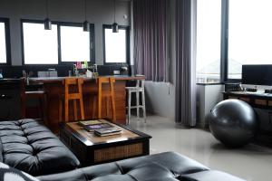 a living room with a couch and a table at Jiwa's House in Ubud