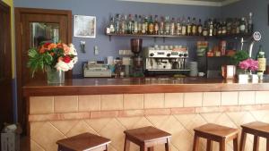 a bar with stools and a counter with a coffee maker at Hospedería Prepirineo in Undués-Pintano