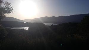 a view of a lake with the sun in the distance at Hospedería Prepirineo in Undués-Pintano