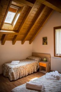 - une chambre avec 2 lits et une fenêtre dans l'établissement Albergo Diffuso Zoncolan, à Ovaro