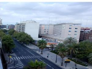 バレンシアにあるApartment La Marinaのヤシの木や建物が並ぶ街道