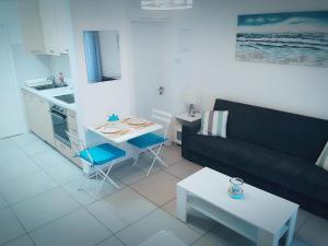 a living room with a couch and a table at Billis Beach Apartment in Limassol