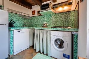 a laundry room with a washer and dryer at Emerald apartment in Alghero Historic Center in Alghero