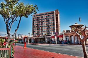a city street with a tall building on the side of the road at Hotel Villa Marina in Ensenada