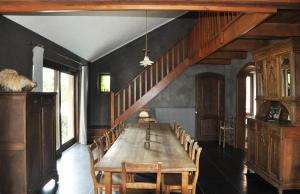 a dining room with a wooden table and chairs at Gîte Ferme d'Ortie in Sainte-Ode