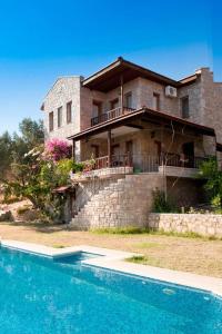 a house with a swimming pool in front of it at Villa Olive Garden in Datca