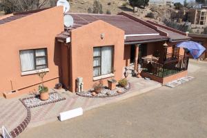an overhead view of a house with an umbrella at Rio Guest House in Tikoe