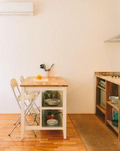 a table and a chair in a kitchen with a table at Apartment Savska in Zagreb