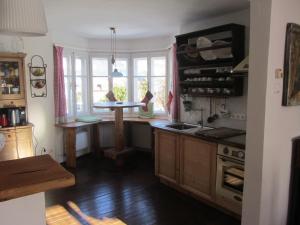 a kitchen with a table in the middle of a room at Chalet "Hoamatl" in Haus im Ennstal