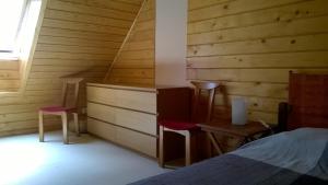 a bedroom with a bed and a table and chairs at Entre Paimpol et Bréhat ! in Ploubazlanec