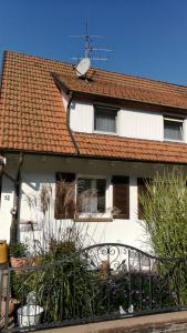 a white house with a roof and a fence at Ferienwohnung Adelsberg in Alpirsbach