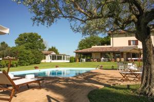 a house with a swimming pool in a yard at Casa Tentoni - Guest House in Misano Adriatico