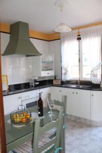 a kitchen with a table with a bottle of wine at Casa Gusber I in El Paso