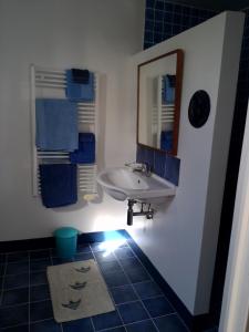 a bathroom with a sink and a mirror at Villa Mirabel in Île du Levant