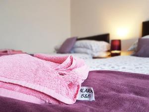 a bed with a blanket and pillows on it at ALARA Bed and Breakfast in Sheffield
