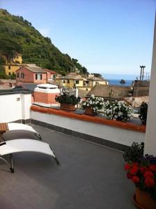 a balcony with chairs and a view of a city at SoleMare in Monterosso al Mare