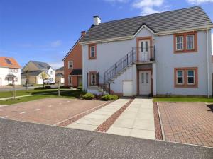 a large white house with a staircase on it at Sea Esta in Anstruther