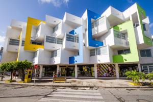 un gran edificio blanco con balcones coloridos en una calle en Apartamentos Turisticos In Di Morgan's Canon, en San Andrés