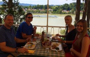 
people sitting at a table with food at Hotel-Restaurant Faustschlössl in Feldkirchen an der Donau

