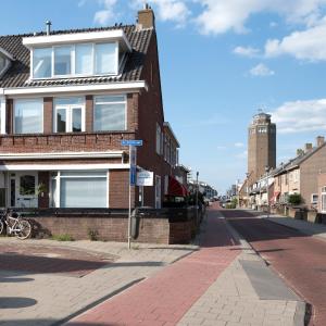 a brick house on a street with a street sign at NEW Appartment Zandvoort! in Zandvoort