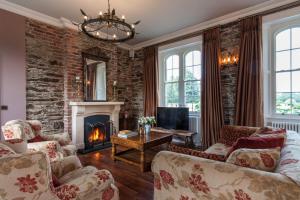 a living room with a brick wall and a fireplace at Wilton Castle in Enniscorthy