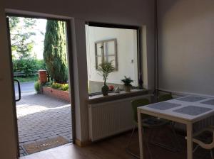 a dining room with a table and a table and a window at Pracownia pod 7 in Szczecin