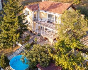 an overhead view of a house with a pool and trees at Vila Sofia - Pool, Sauna & Nature Escape in Varna City