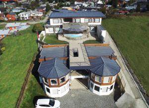 an aerial view of a house with a pool at Dein Haus Hotel y Departamentos in Puerto Varas