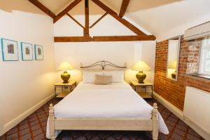 A bed or beds in a room at Donington Park Farmhouse Hotel 