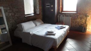 a bedroom with a bed with towels on it at Castello di Trisobbio in Trisobbio