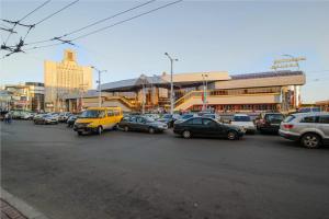a parking lot full of cars in a city at Hostel Platskart in Minsk
